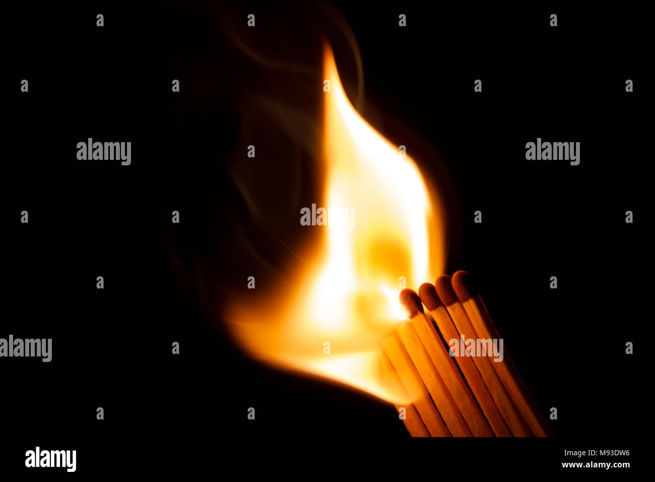A row of matches is being ignited, spreading the fire Stock Photo