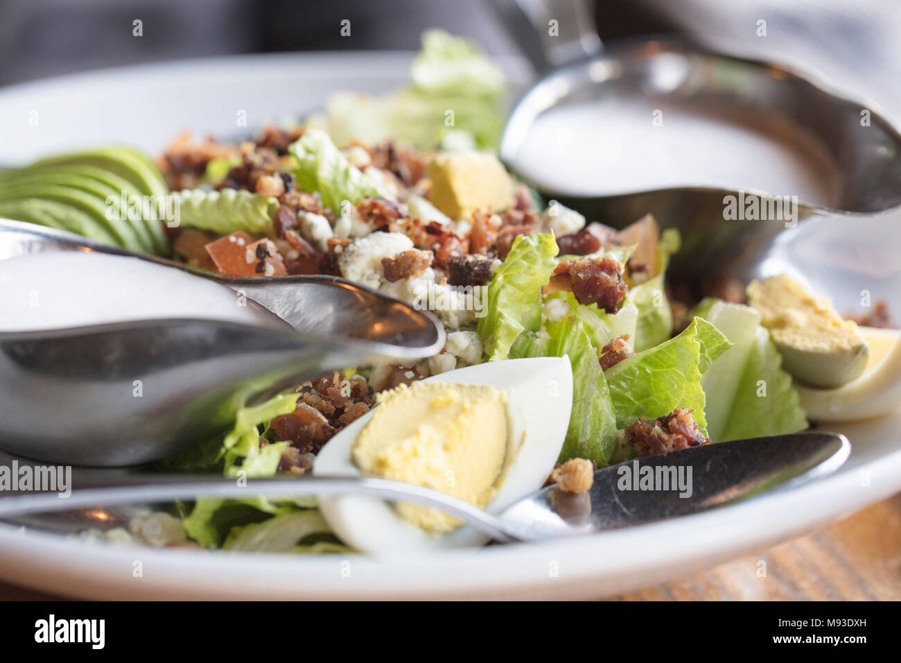 Dinner Cobb Salad made with romaine lettuce, tomatoes, eggs, avocado