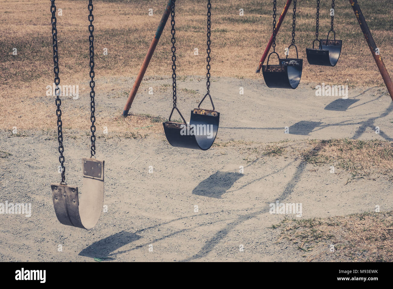 swings on old playground  , vintage outdoor playground Stock Photo