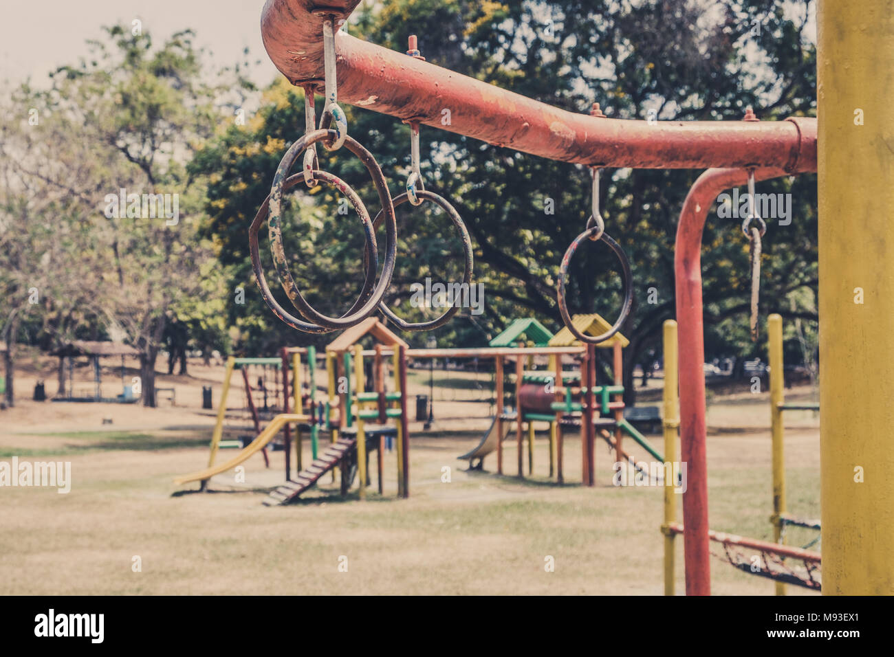 rings hanging on climbing frame - jungle gym on old outdoor playground  - Stock Photo