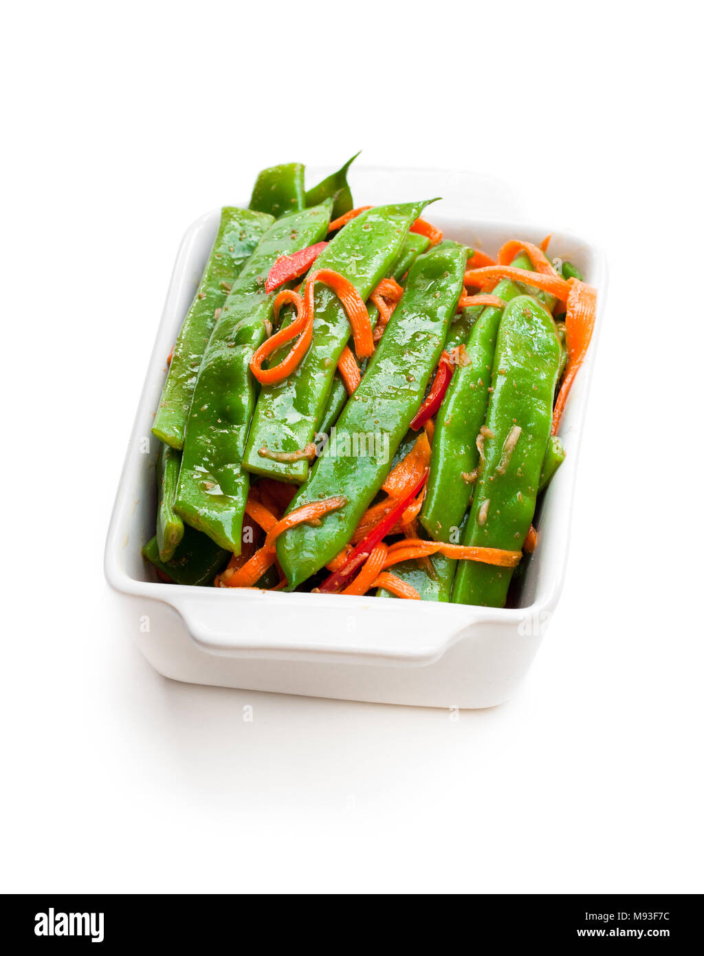 Green string beans and carrot with spices isolated on white Stock Photo