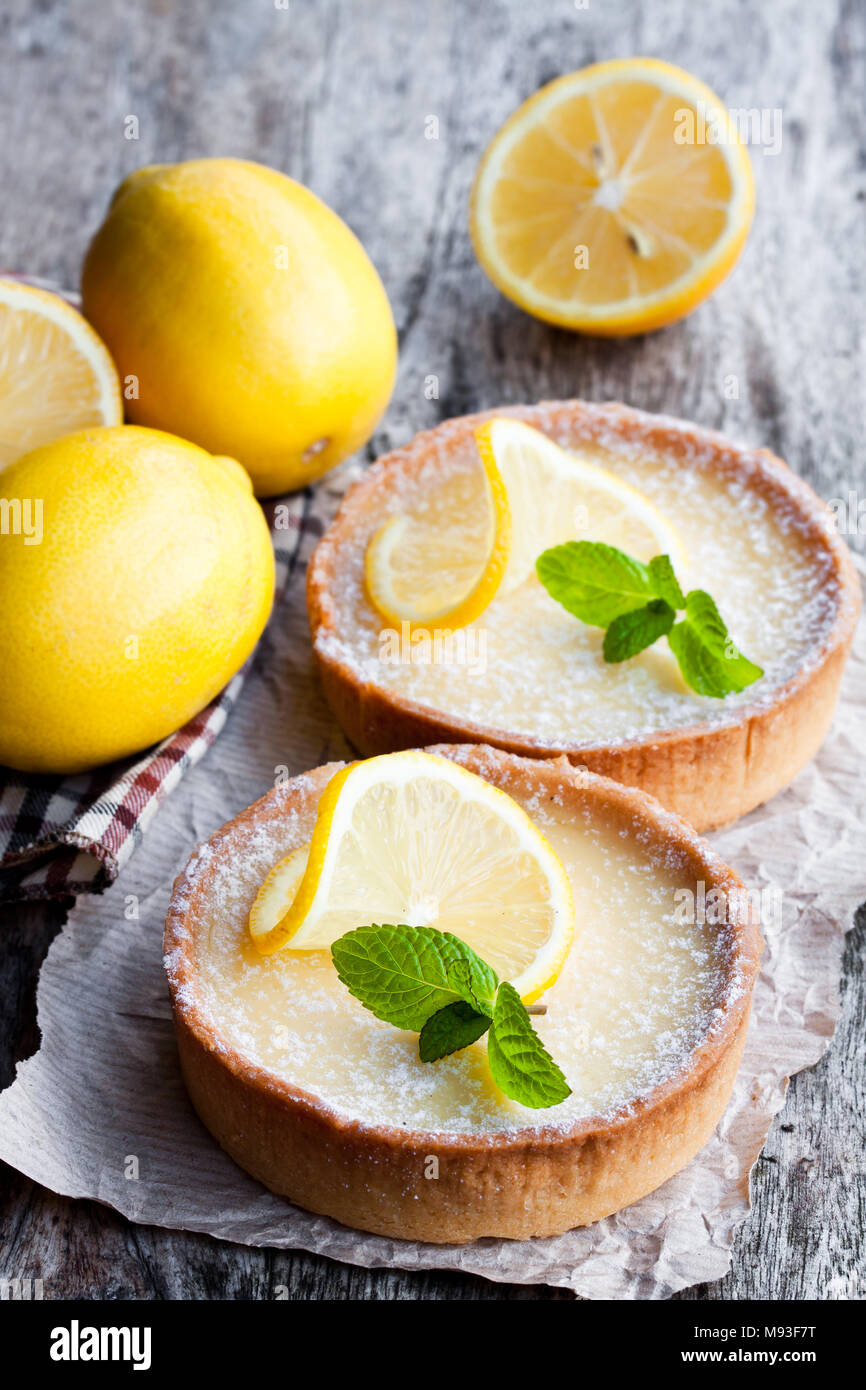 Mini  lemon tarts on wooden table Stock Photo