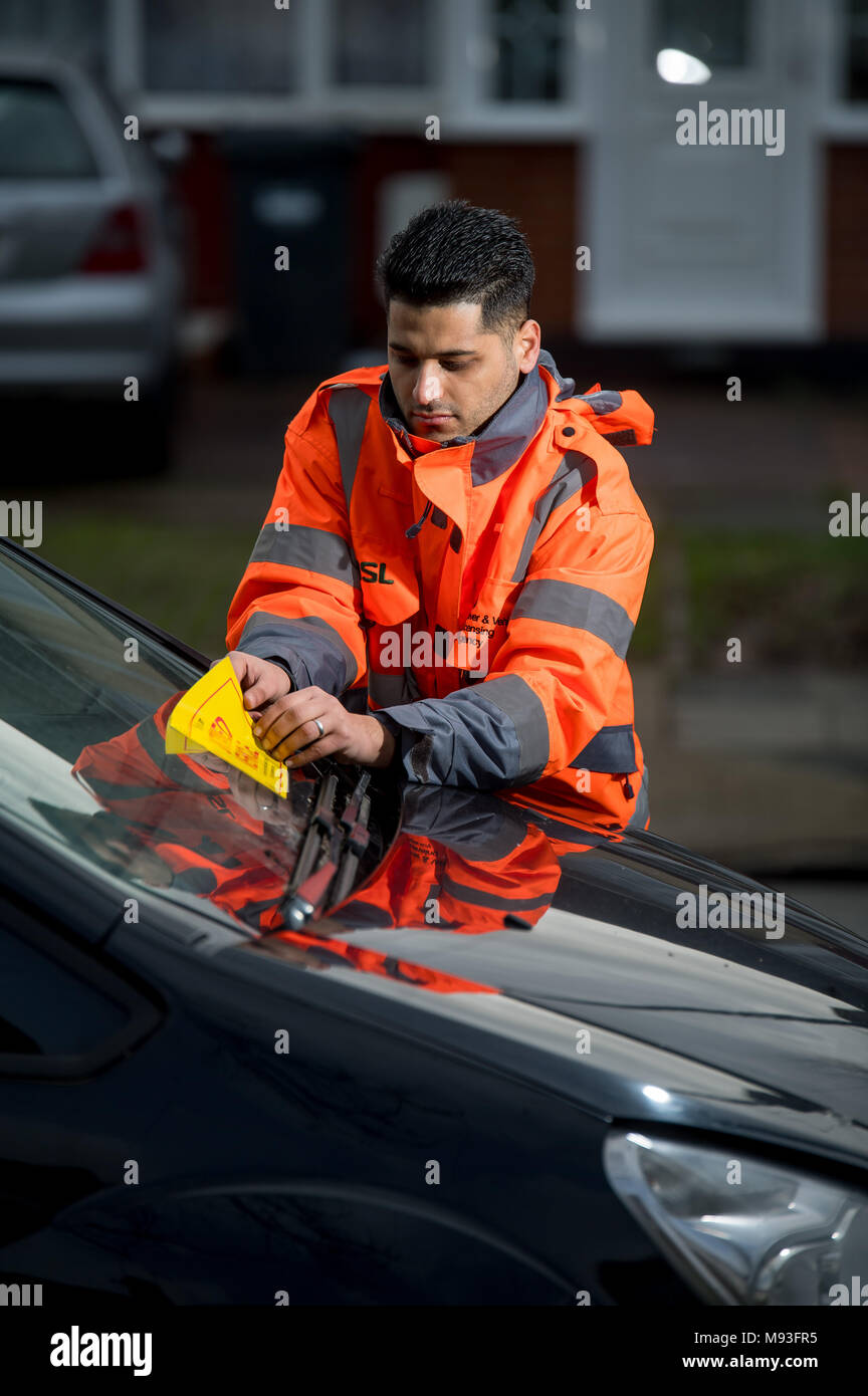 Wheel clamping of untaxed vehicles is becoming more common with the paper tax disc display being abolished and car tax needing to be paid online. Stock Photo