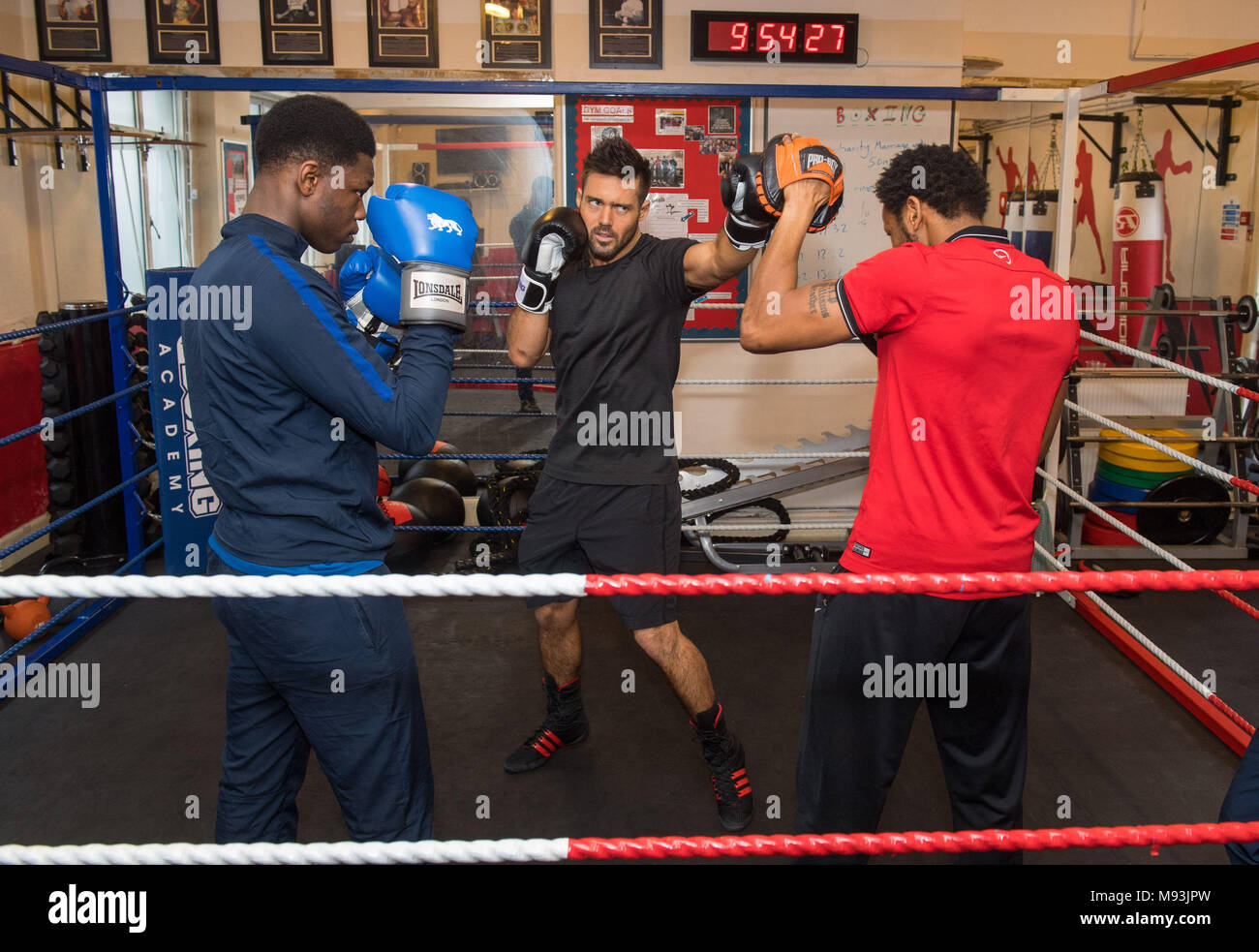 Previously unissued photo dated 13/03/18 of Spencer Matthews (centre) taking part in a training session with coach Jermaine Williams (right) and student Tipot, during a visit to the Boxing Academy, a Comic Relief funded sport project in Hackney, London, ahead of Sport Relief boxing challenge. Stock Photo
