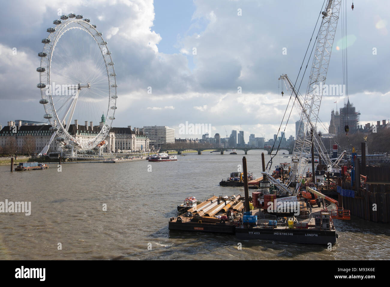 Building works on the Thames northbank, with the London Eye in the distance, central London, England, UK Stock Photo