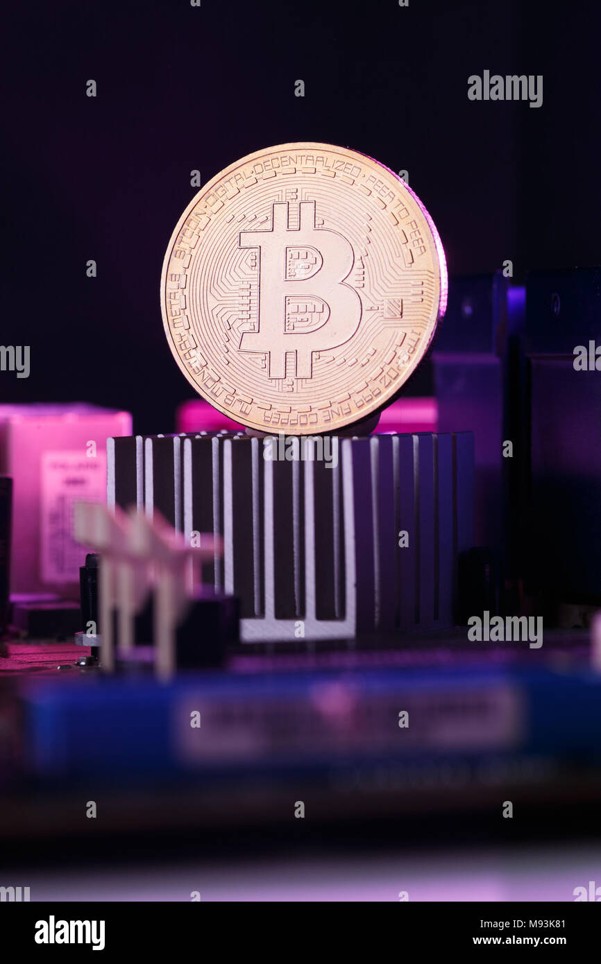 Picture of virtual currency, bitcoin and processor on pink background Stock Photo
