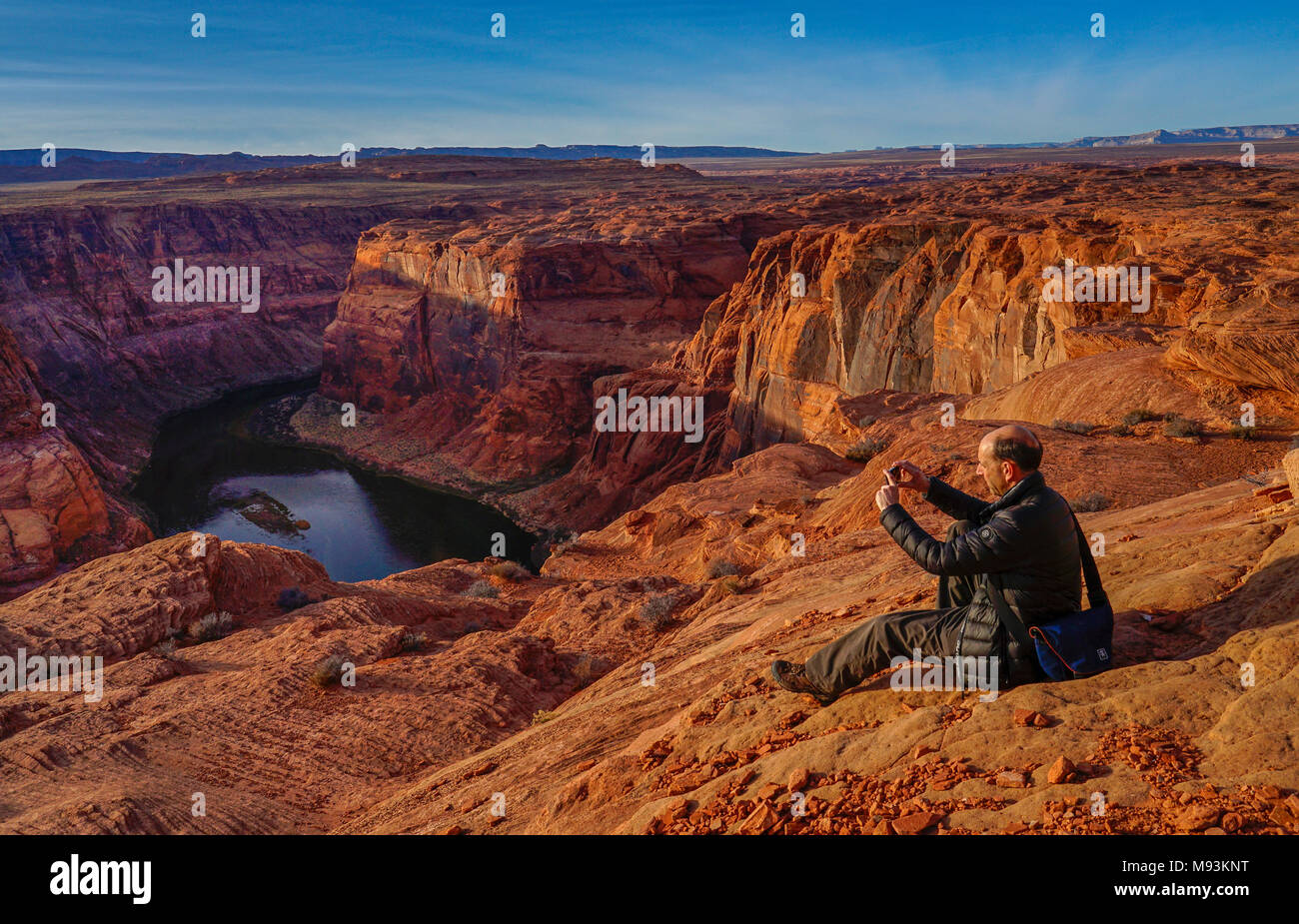 Tourist taking a mobile phone photo of Colorado River at horseshoe bend Canyon,Page,Arizona,USA Stock Photo