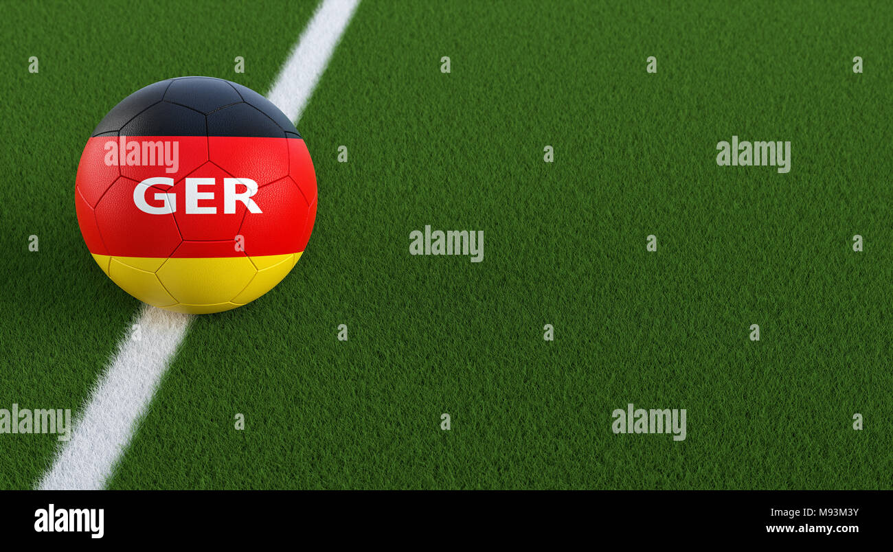 Soccer ball in german national colors on a soccer field. Copy space on