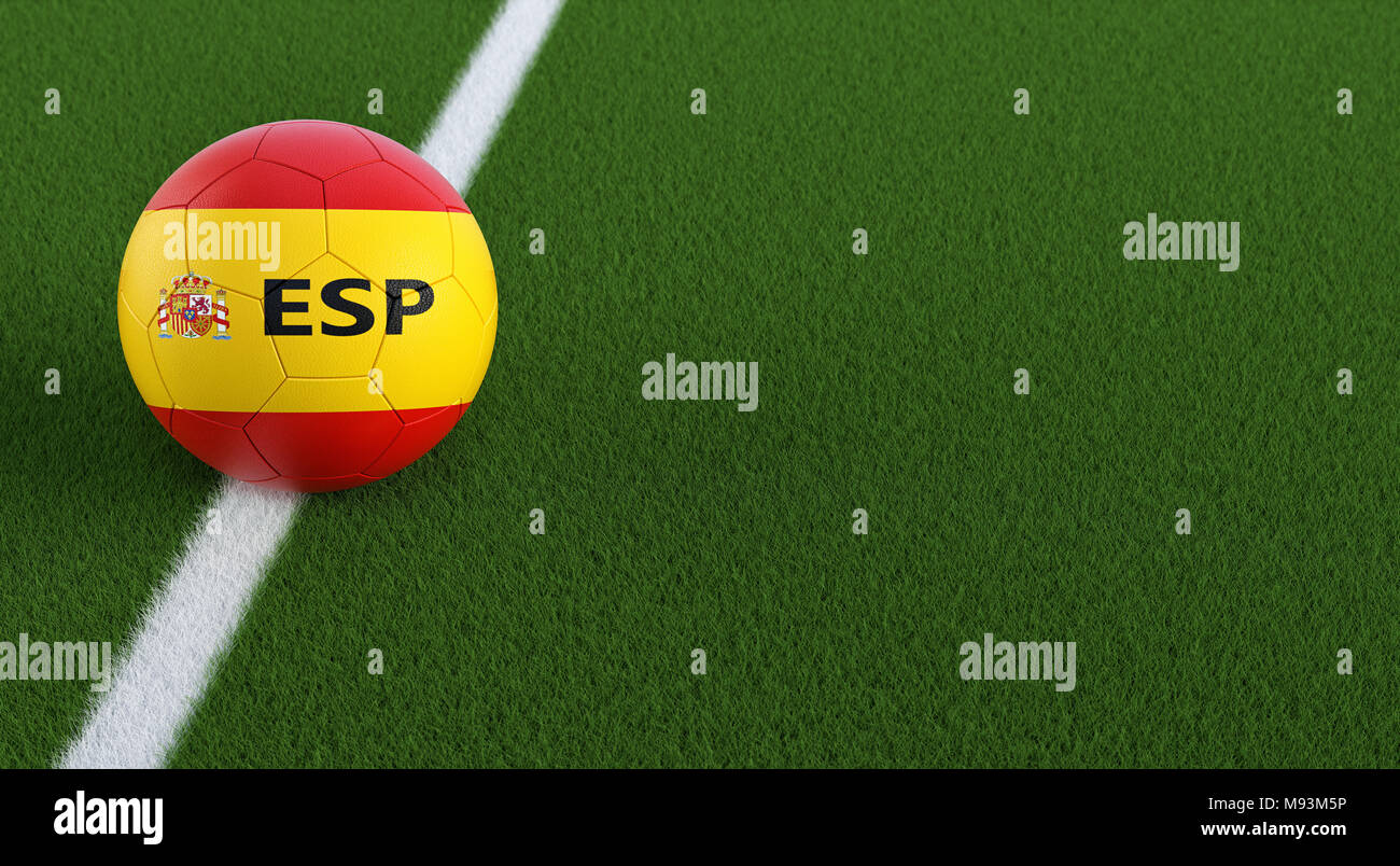 Soccer ball in spanish national colors on a soccer field. Copy space on