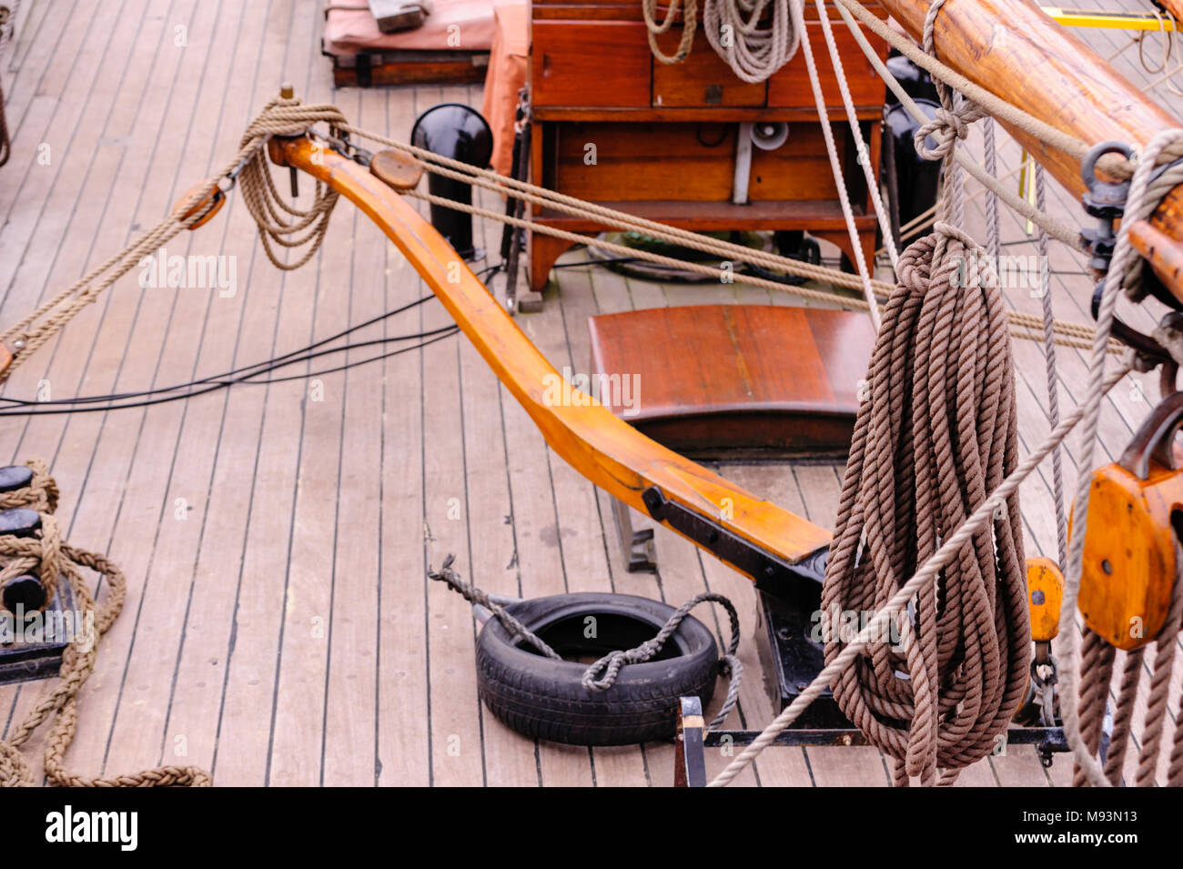 View on upper deck of anchored sailing ship with tiller at daylight in Port of Hamburg, Germany. Stock Photo