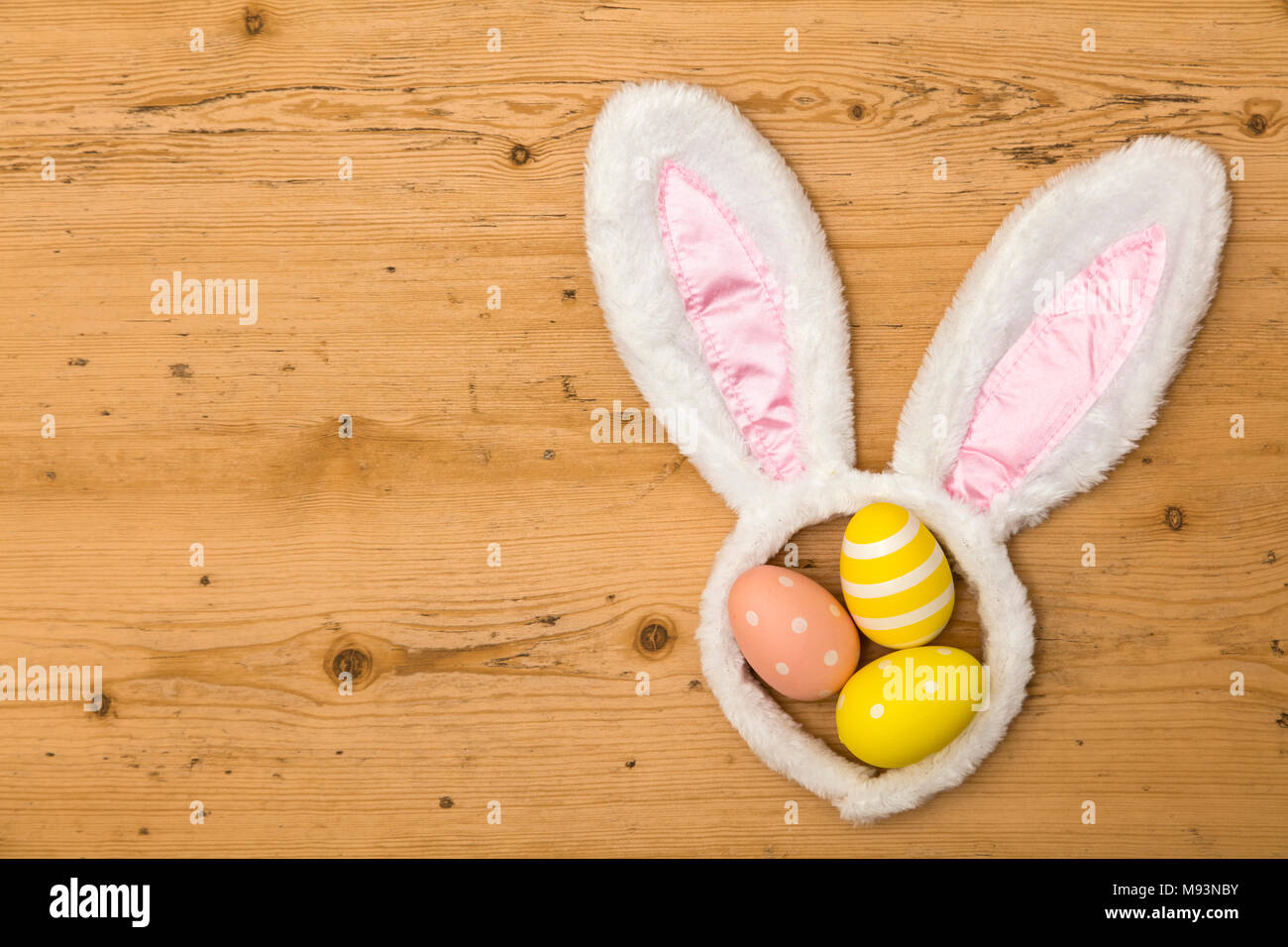 Easter holiday background with bunny ears and easter eggs Stock Photo ...