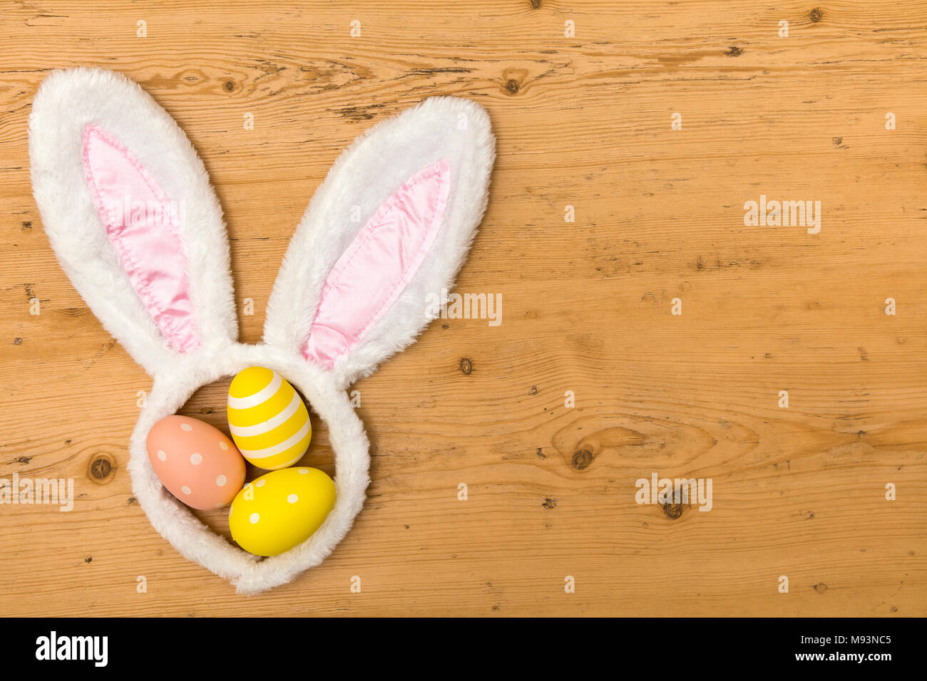 Easter holiday background with bunny ears and easter eggs Stock Photo ...