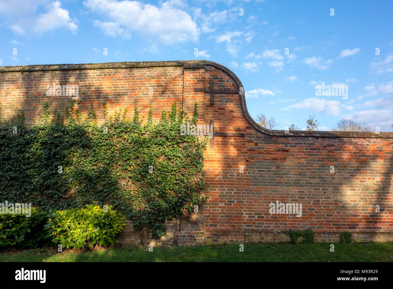 Old brick wall with metal retaining supports Stock Photo
