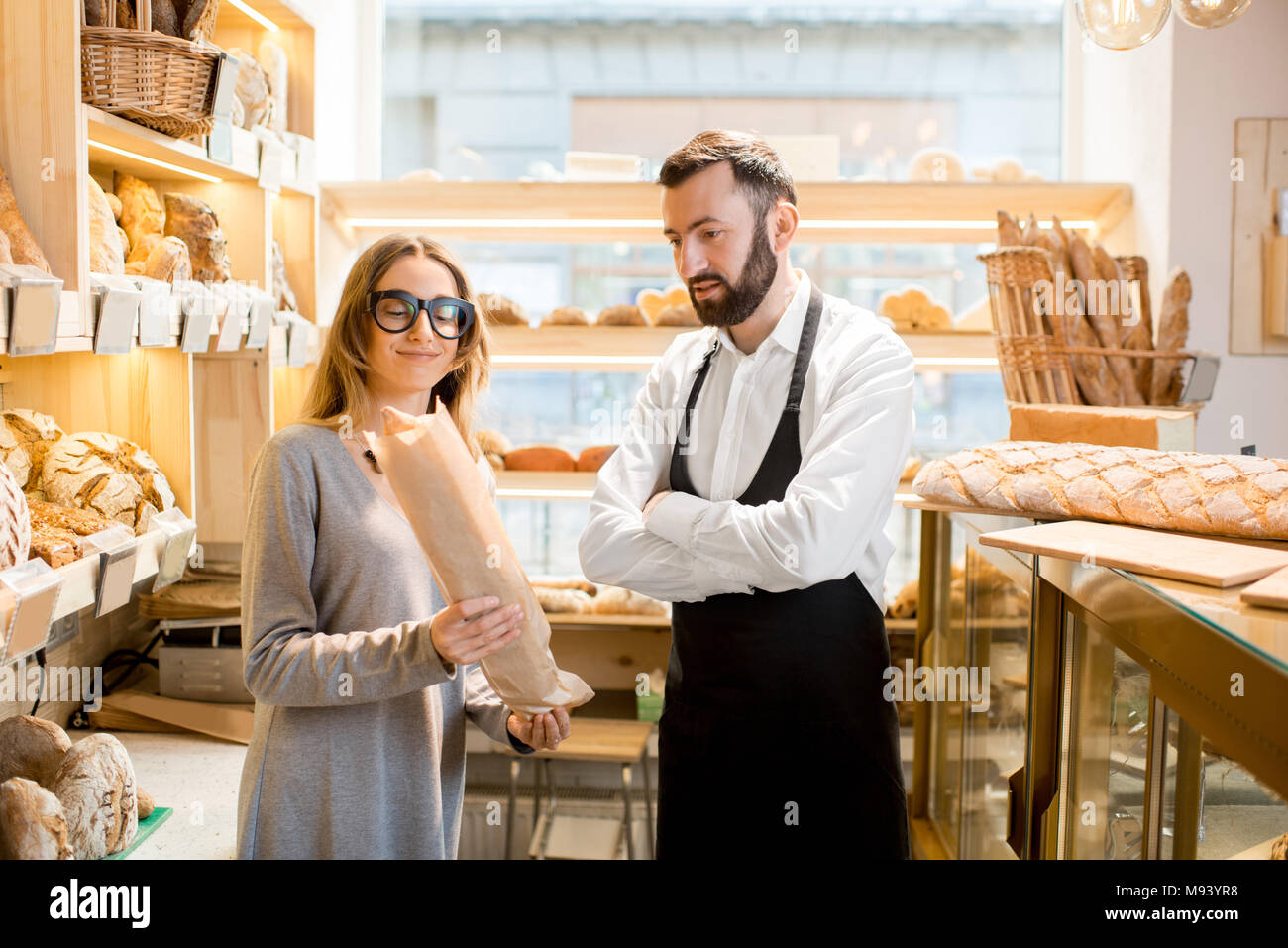 Owner of the bakery store with bread seller Stock Photo Alamy