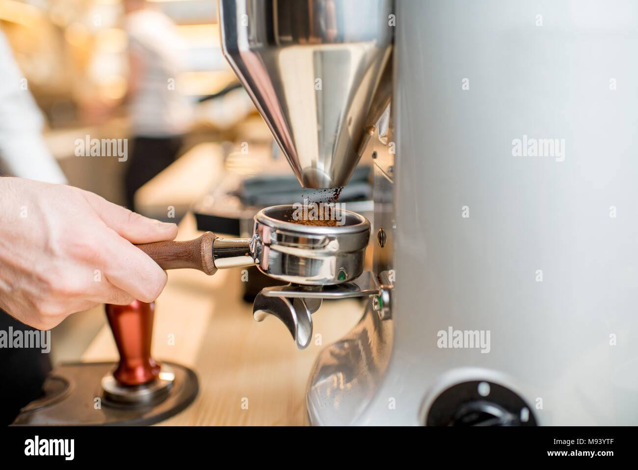 Grinding a coffee into the handle of the coffee machine Stock Photo Alamy