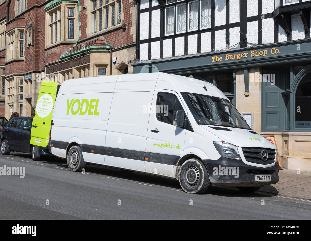 Yodel delivery van parked up making a delivery in a small town in England, UK. Stock Photo
