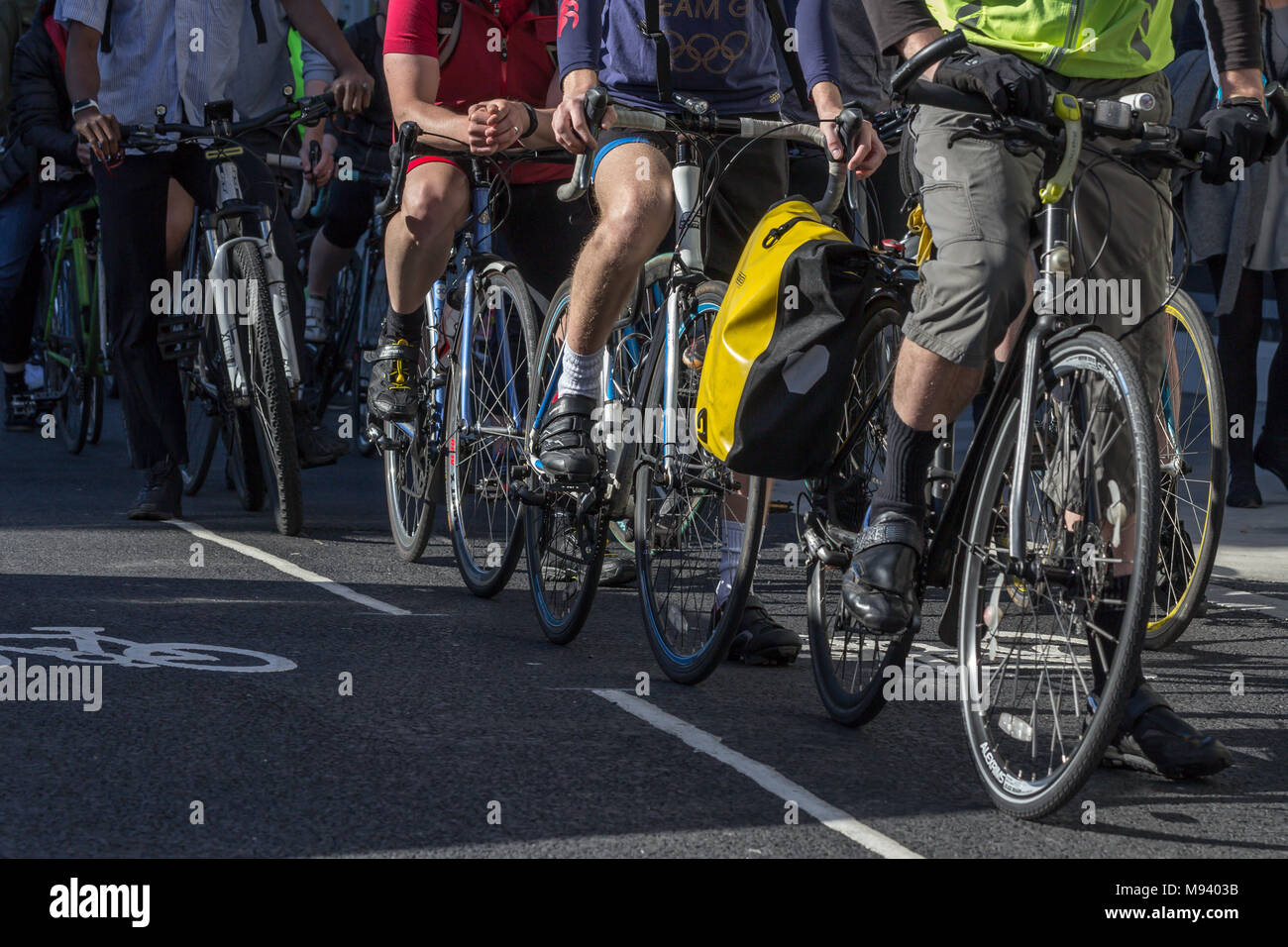 London cyclists cycling to work along a cycle lane during the morning