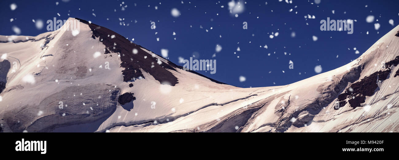 Snow capped mountain on a sunny day Stock Photo - Alamy