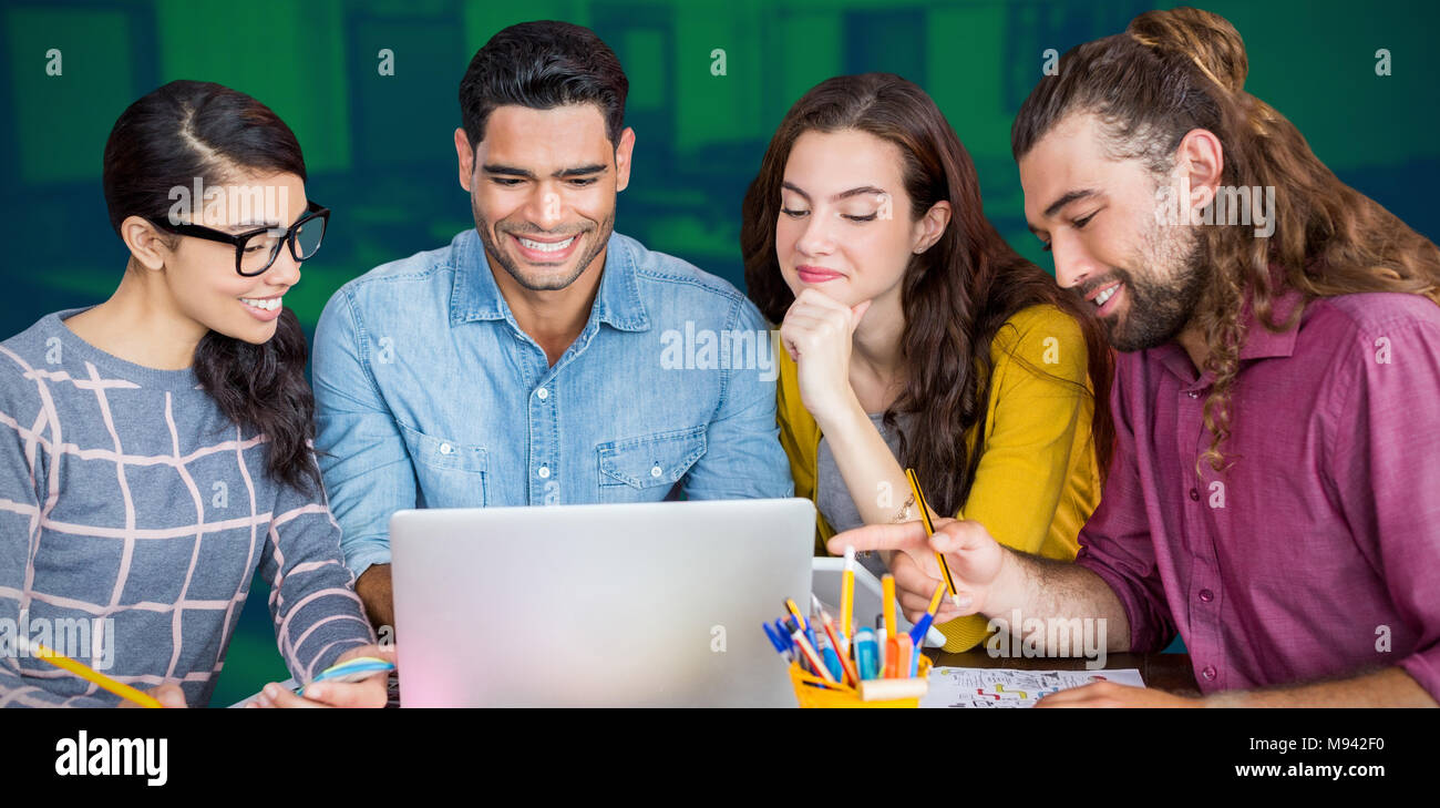 Composite image of colleagues discussing over laptop Stock Photo