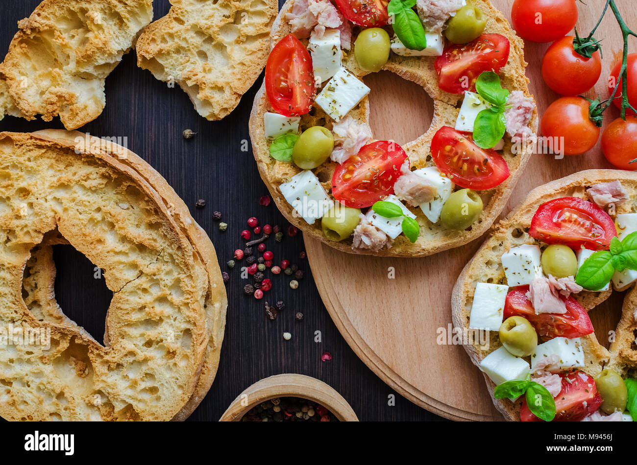 Italian Appetizer Friselle Italian Dried Bread Friselle On Wooden Board With Tomatoes Cherry Olives Tuna Basil And Peppercorns Italian Food Heal Stock Photo Alamy