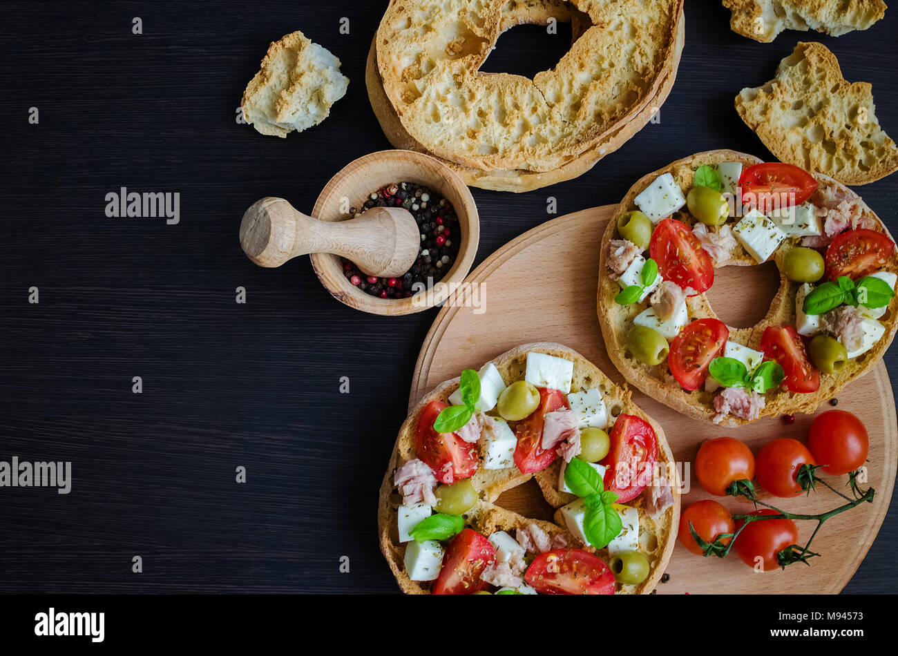 Italian Appetizer Friselle Italian Dried Bread Friselle With Tomatoes Cherry Cheese Mozzarella Olives Tuna Basil And Pepper In Wooden Pounder It Stock Photo Alamy