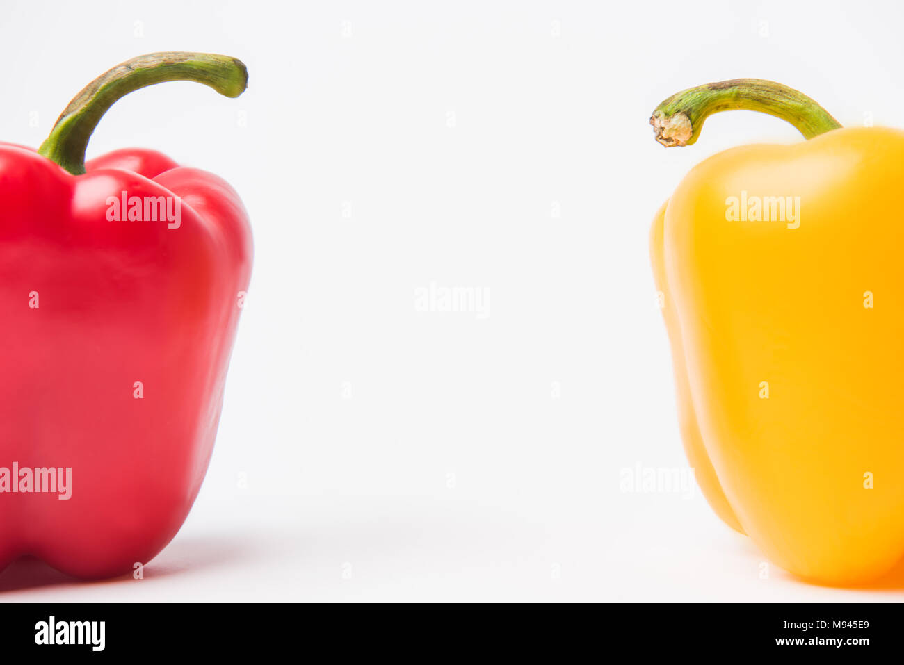 red and yellow bell peppers, on white background Stock Photo - Alamy