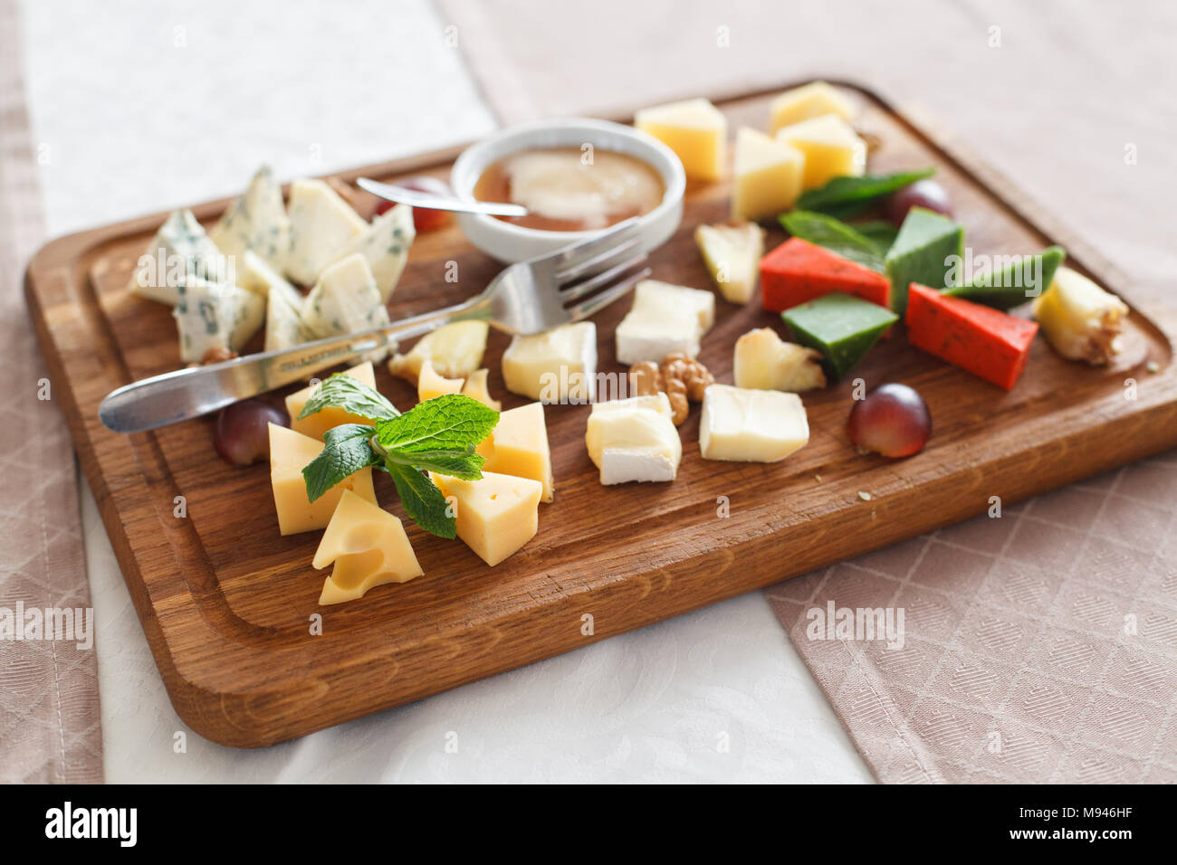 Cheese plates served with grapes, jam and nuts. Cheese allsorts. Dorblu