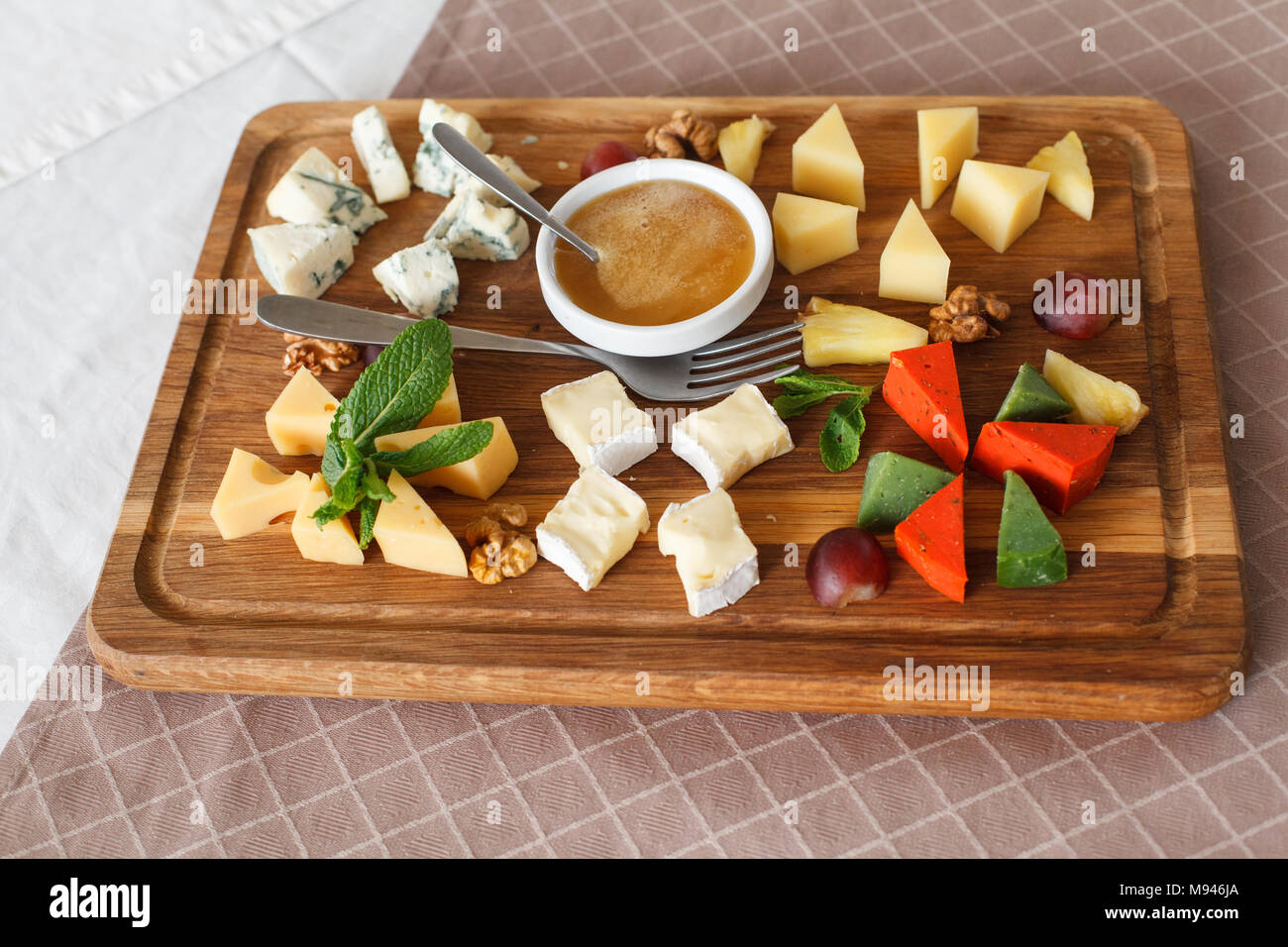 Cheese plates served with grapes, jam and nuts. Cheese allsorts. Dorblu