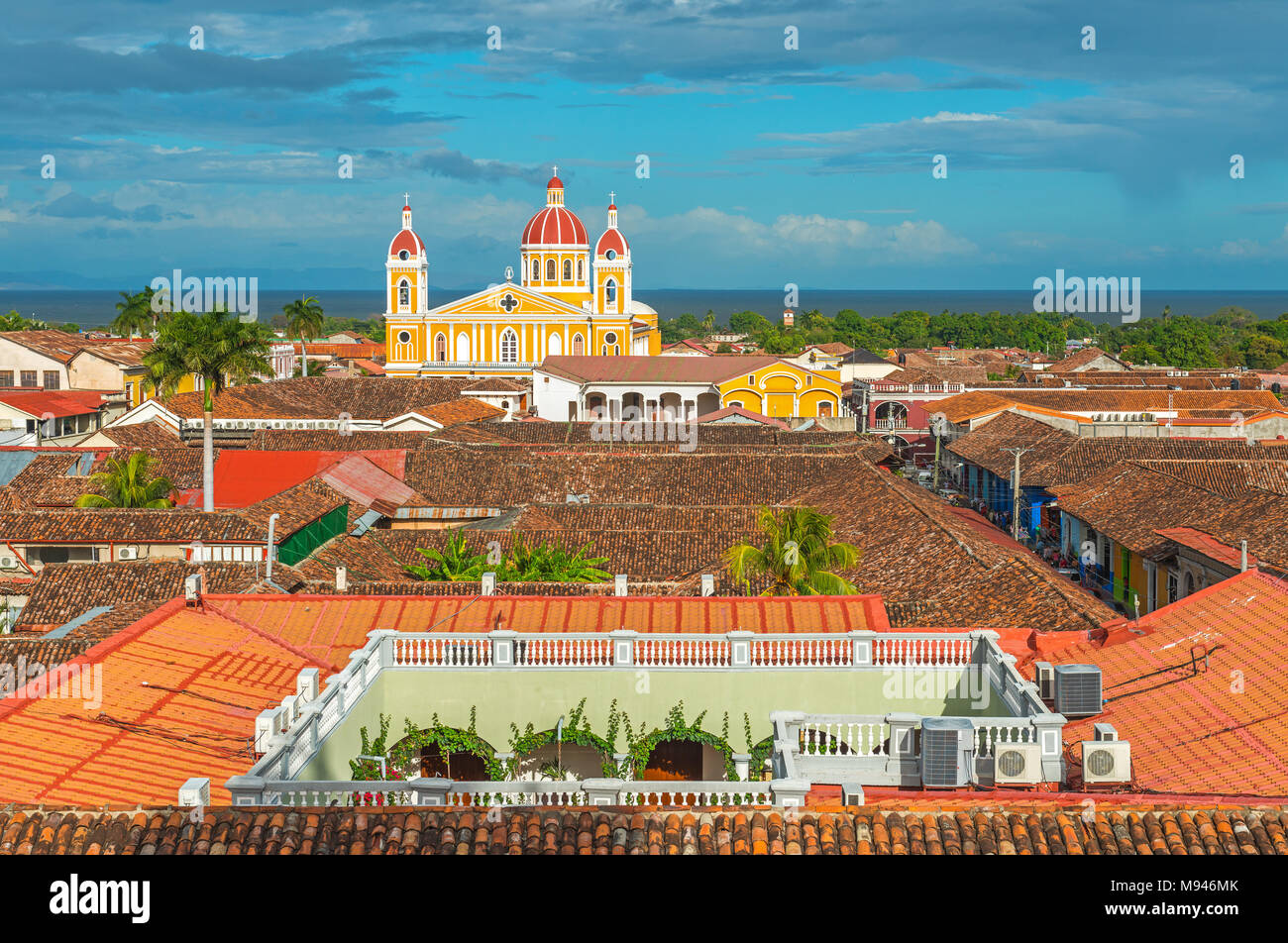 Cityscape of Granada City at sunset with colonial style architecture at sunset and the Nicaragua lake in the background, Nicaragua, Central America. Stock Photo