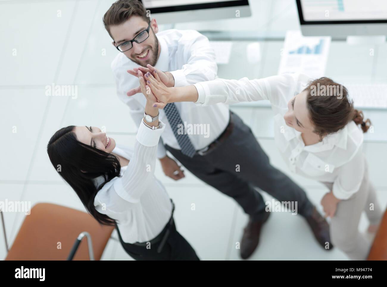 successful business team giving each other a high five Stock Photo - Alamy