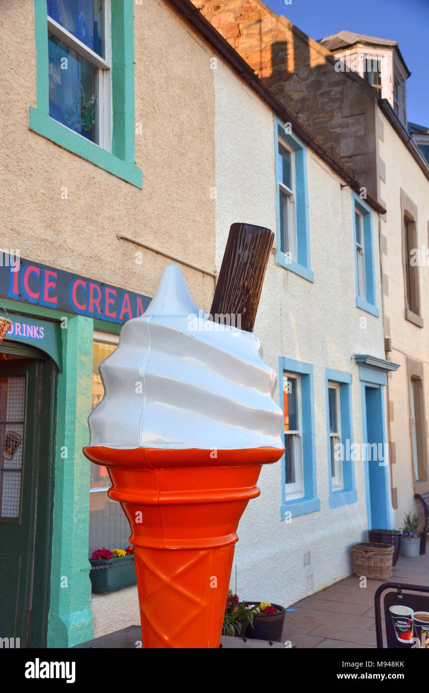 A large ice cream cone and chocolate flake sign outside an ice cream