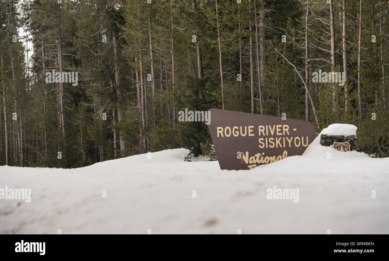 Fresh snow covering the boundary marker sign entering Rogue River-Siskiyou National Forest Oregon Stock Photo