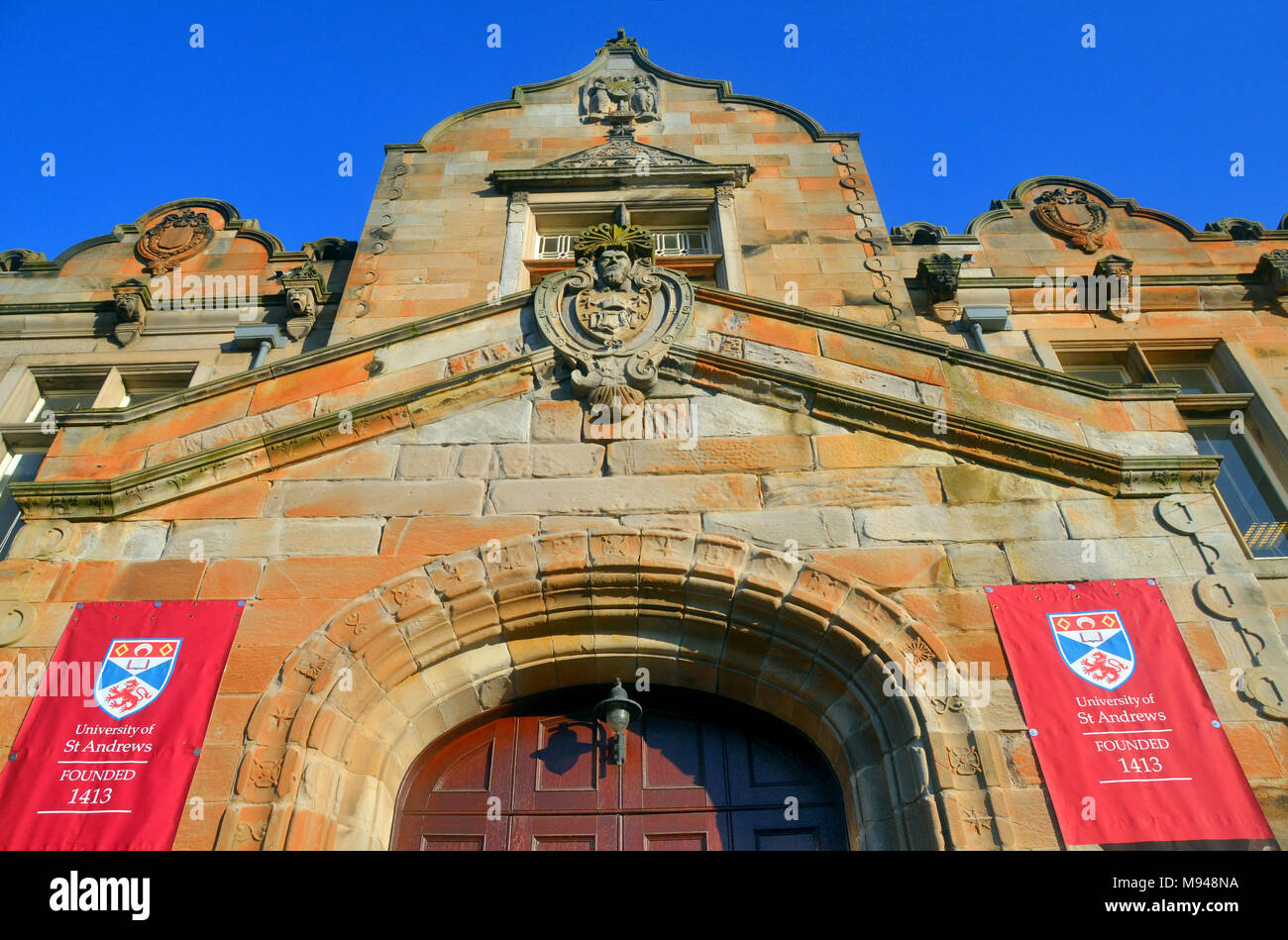 coat of arms banner of St Andrews university, fife, displayed at entrance of one of the student buildings in St Salvators quad. Stock Photo