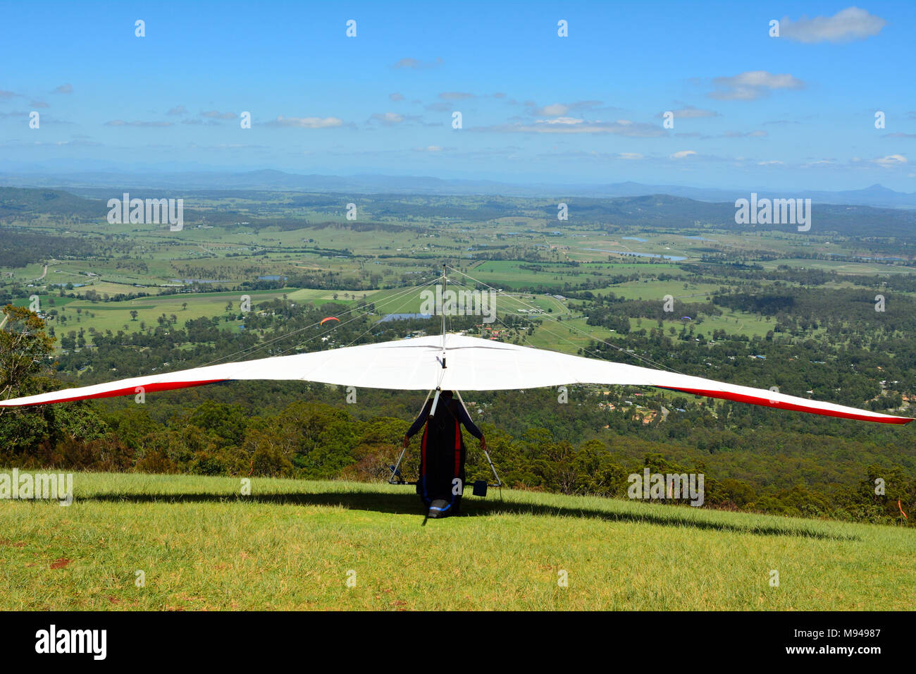Hang-glider taking off a mountain top in Australia. Stock Photo