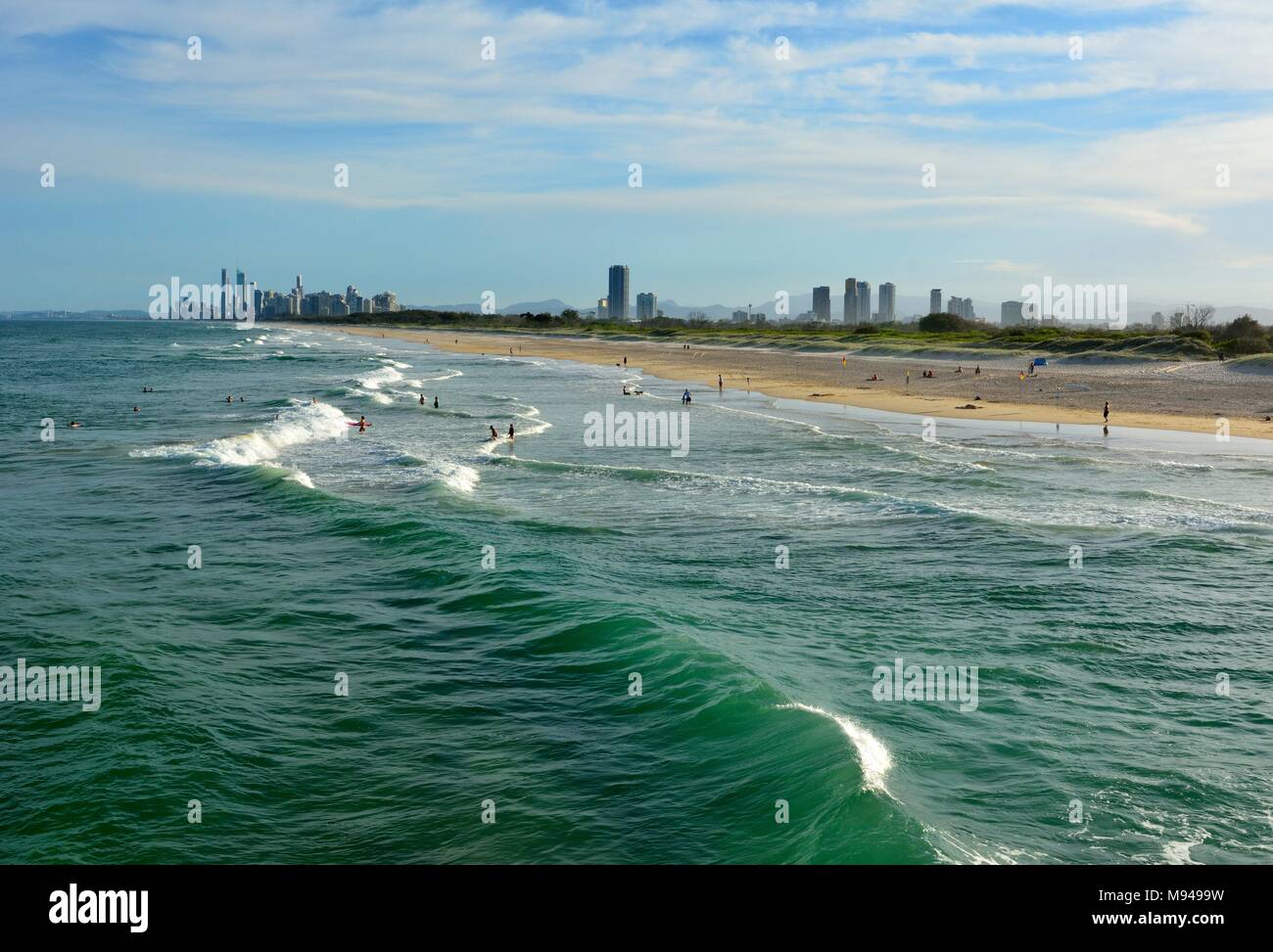 Beach at the Spit, with people and skyscrapers of Surfers Paradise in the distance. Stock Photo