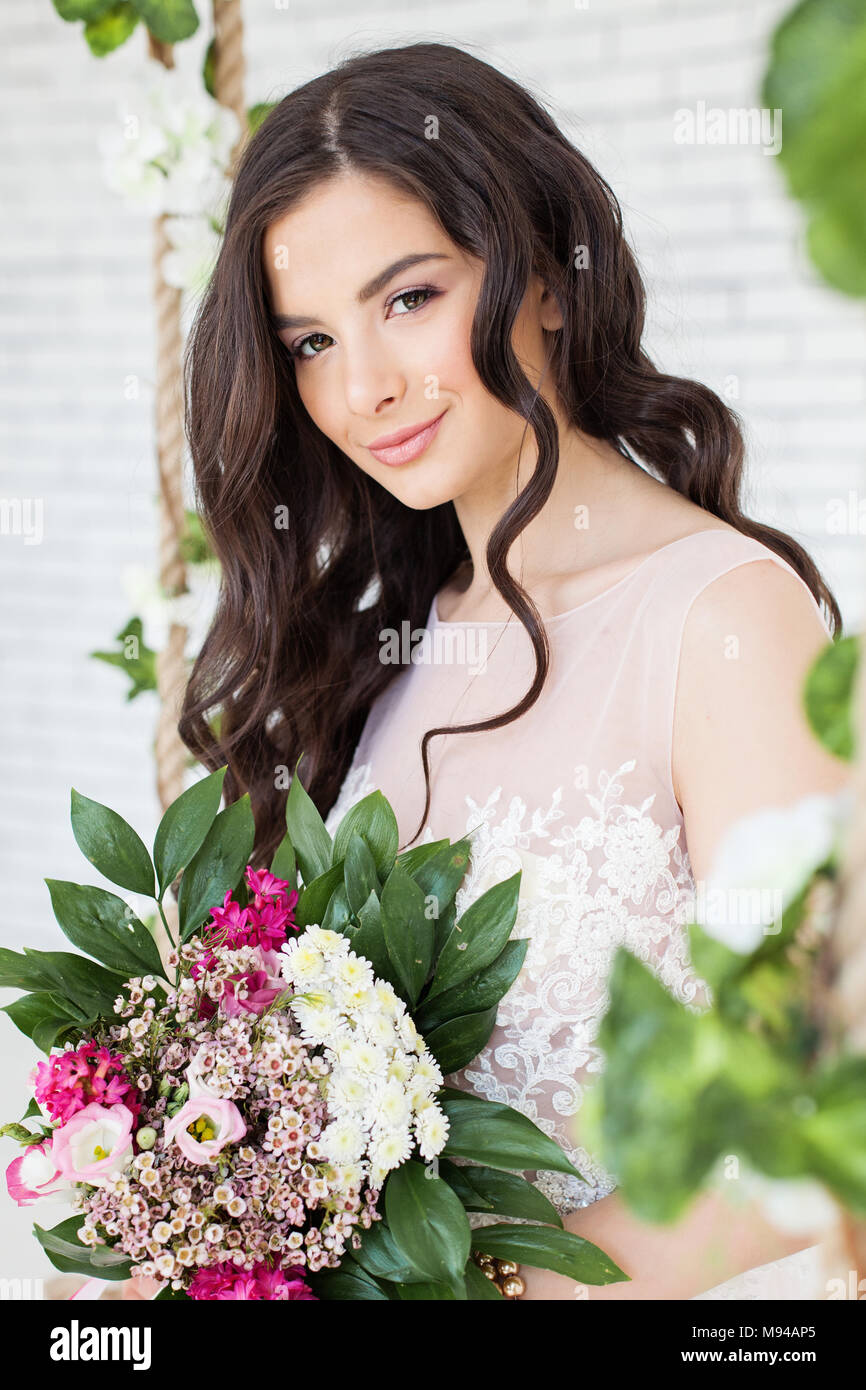 Beautiful Woman with Flowers, Curly Hairstyle and Makeup. Brunette Model Girl Stock Photo - Alamy Beautiful Woman with Flowers, Curly Hairstyle and Makeup. Brunette Model Girl Stock Photo - Alamy