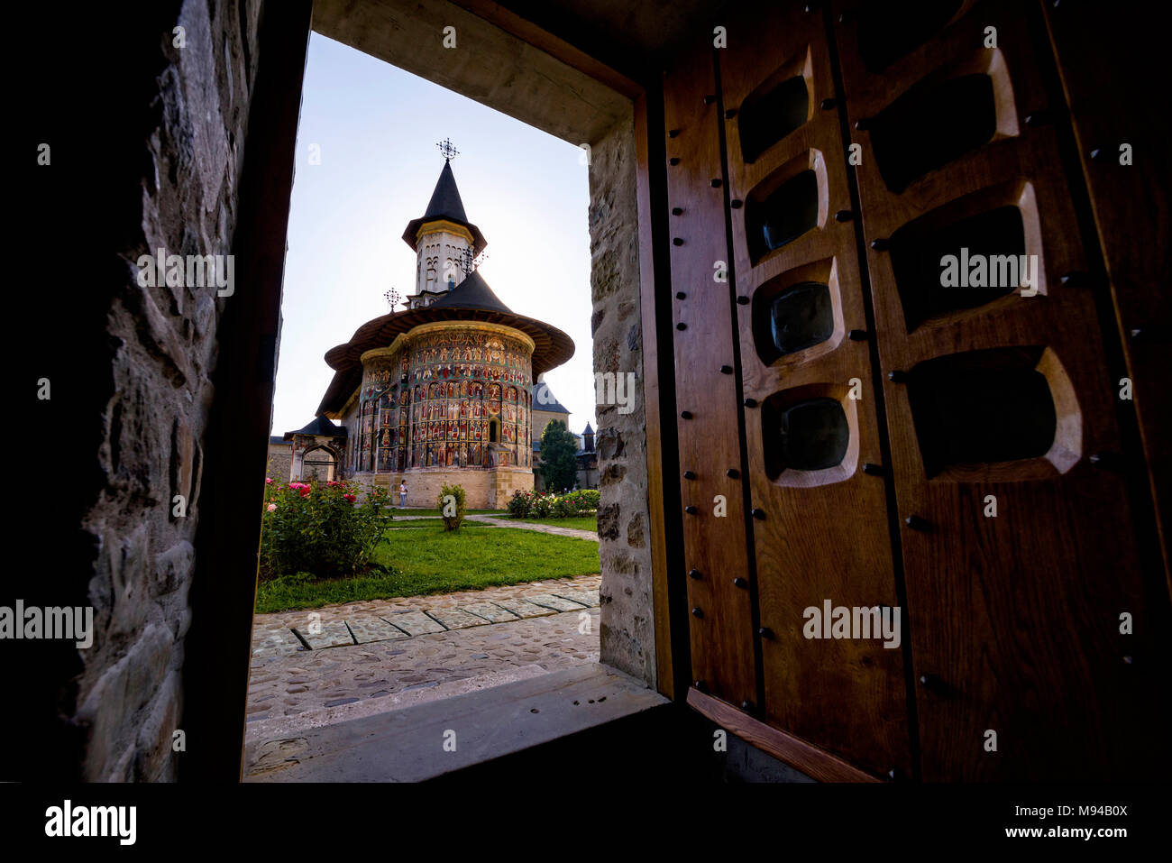 Painted church monastery of Bucovina region in Romania seen through a doorway Stock Photo