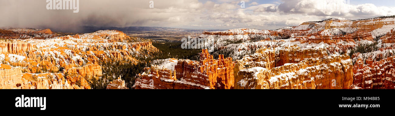 A storm is coming in on the left as clouds and sun move out on the right over Bryce Canyon Stock Photo