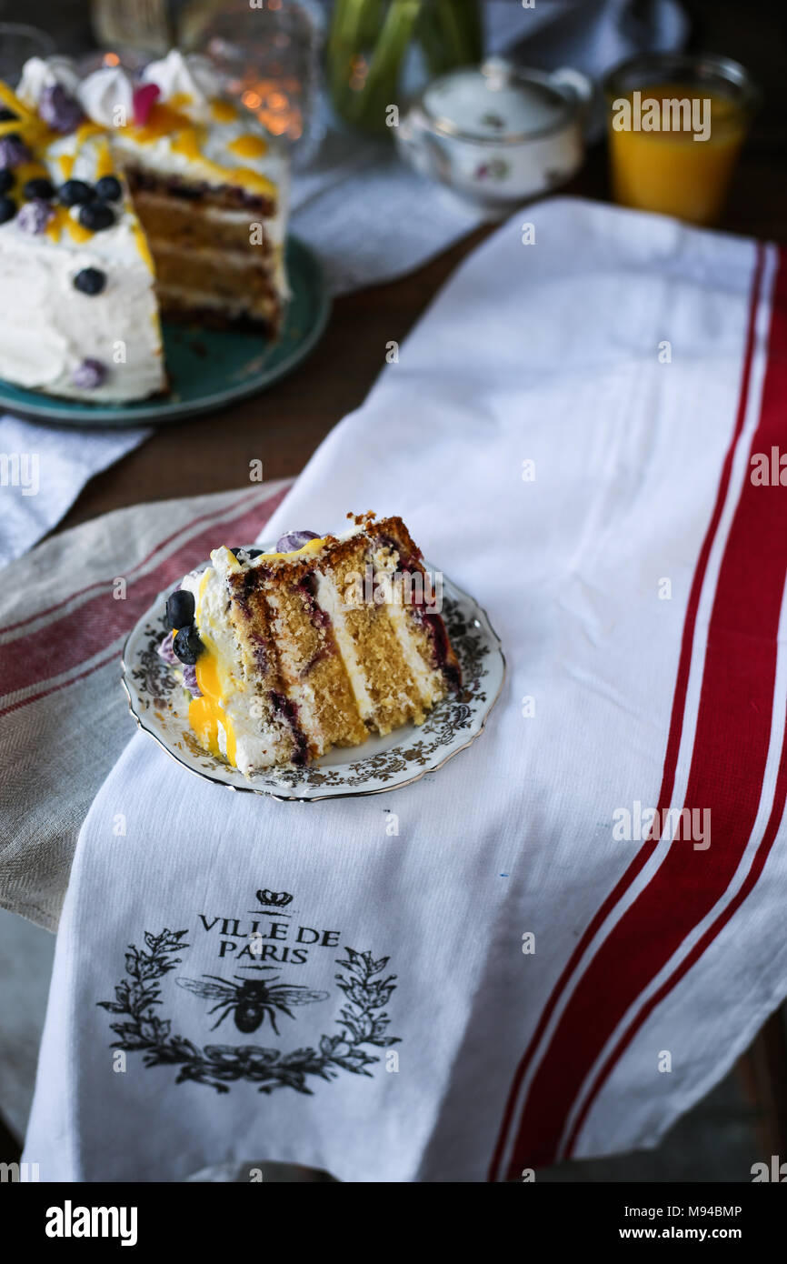Blueberry and lemon curd layered cake with meringues. Stock Photo