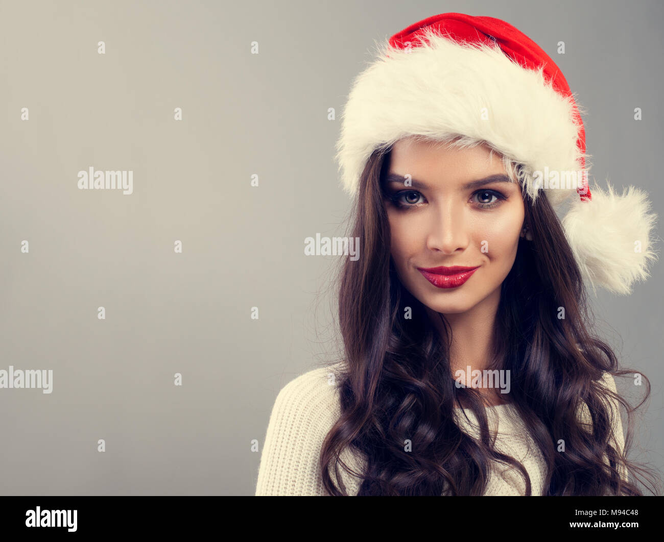 Christmas Woman in Santa Hat Smiling on Banner Background Stock Photo ...