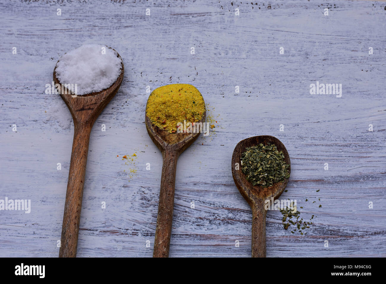 Colorful spices in spoons on white wooden background, Top view/Kitchen ...