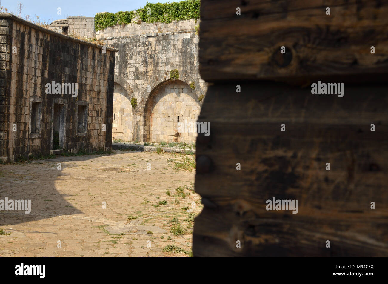 Open old heavy door at the entrance to an old abandoned prison Stock Photo