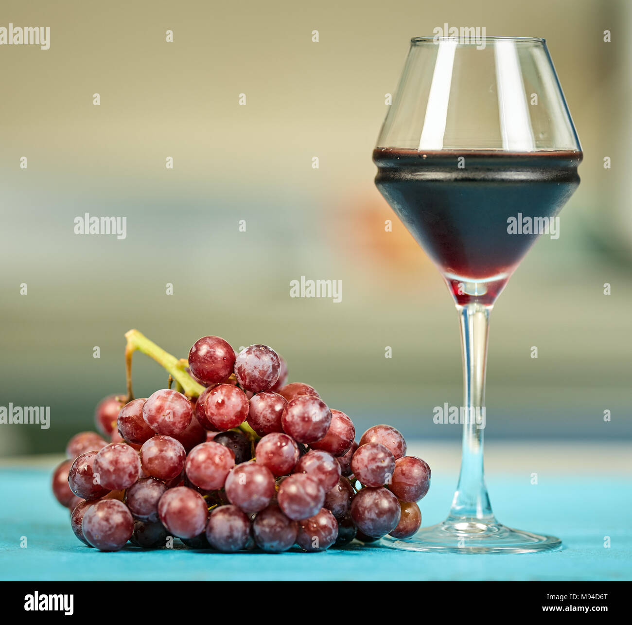 A cluster of red grapes and a glass of dry red wine Stock Photo Alamy