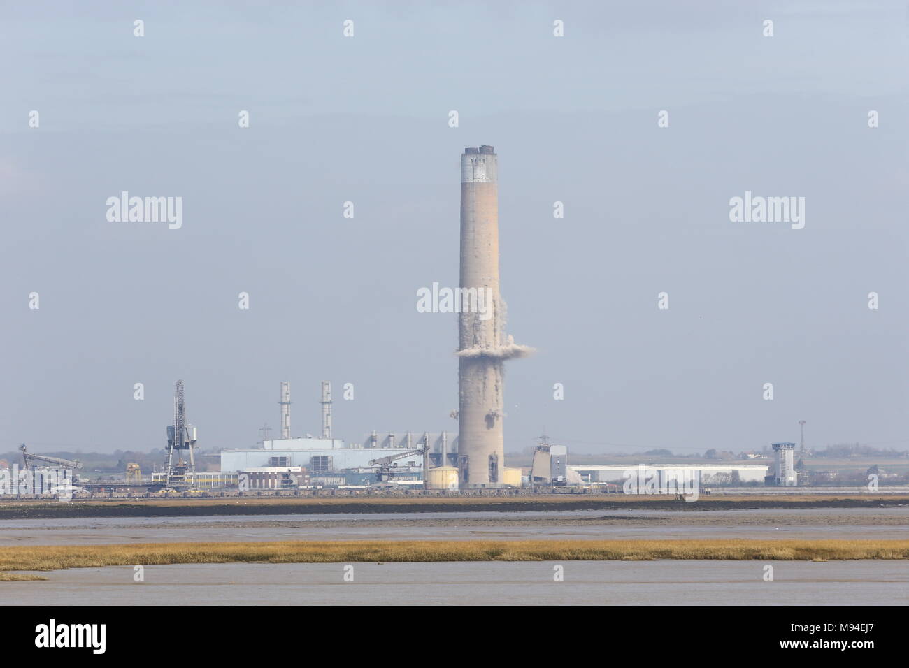 The chimney stack at Uniper's decommissioned, Kingsnorth Power Station, in Hoo, Rochester, Kent, which stands at twice the height of Big Ben, is demolished in a controlled explosion. Stock Photo