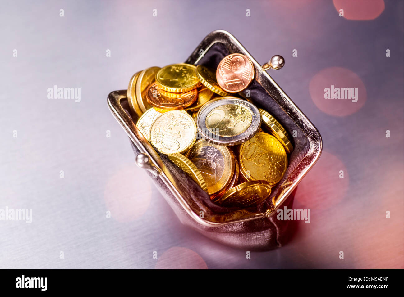 Wallet filled with many coins Stock Photo