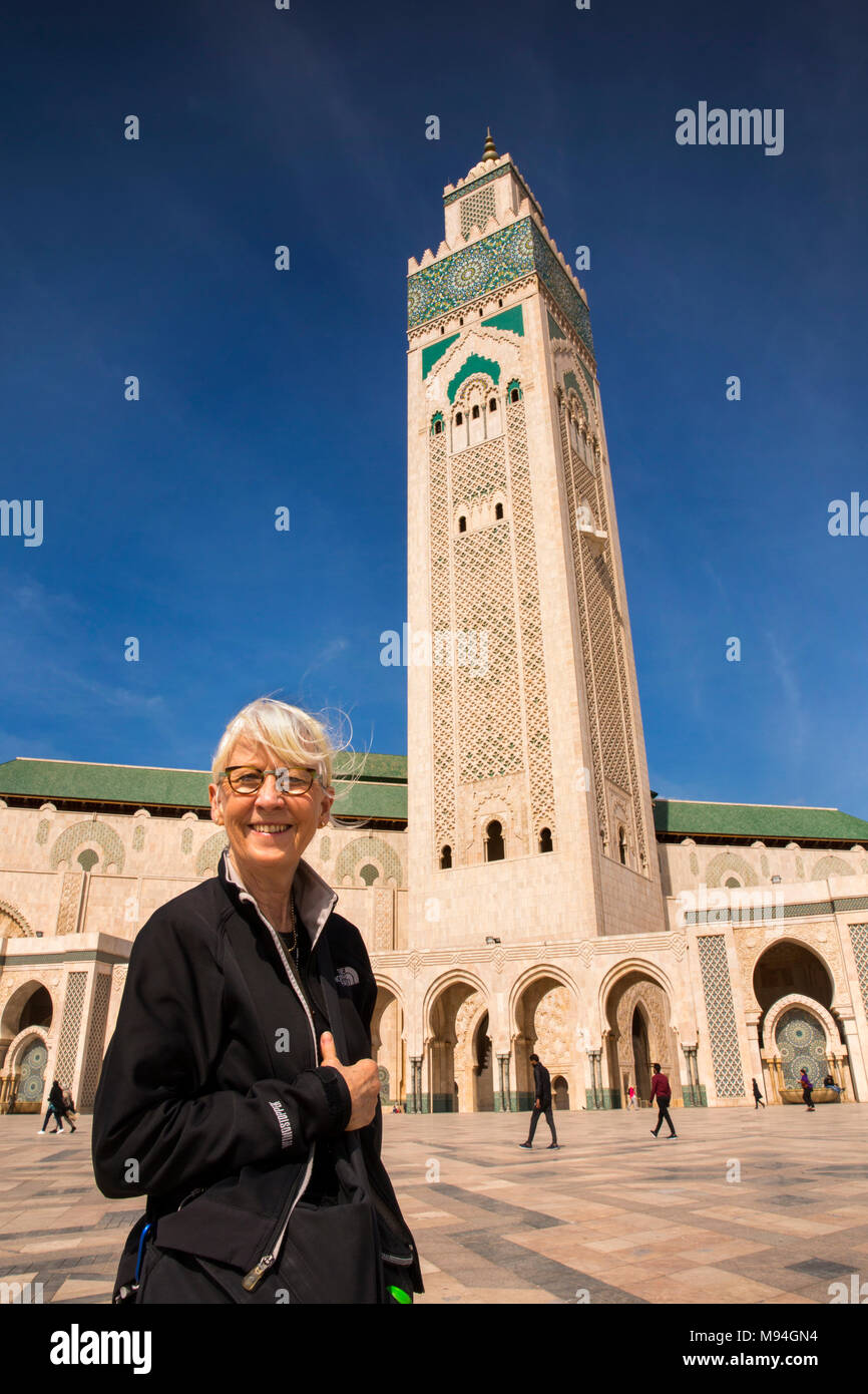 Morocco, Casablanca, tourist posing for souvenir photograph in front of the Hassan II Mosque Stock Photo