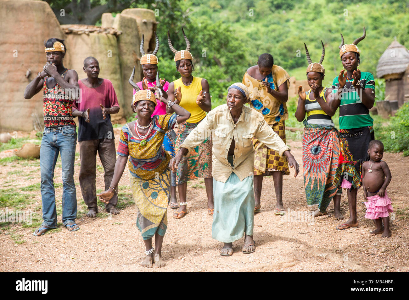 Somba village residents dance in front of their Tata Somba houses, northern Togo. Stock Photo