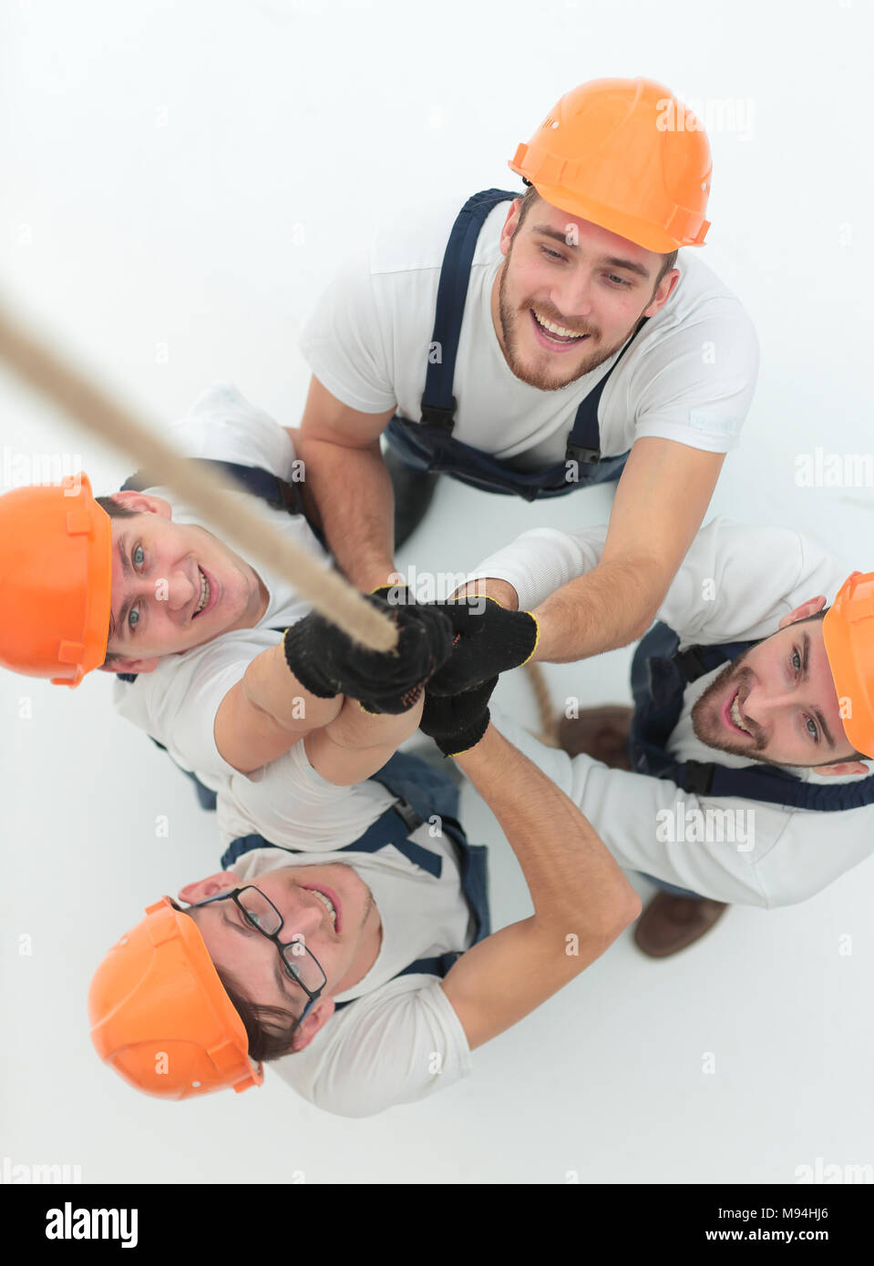 Workers With Ropes view from the top.a group of workers pulling a rope Stock Photo - Alamy