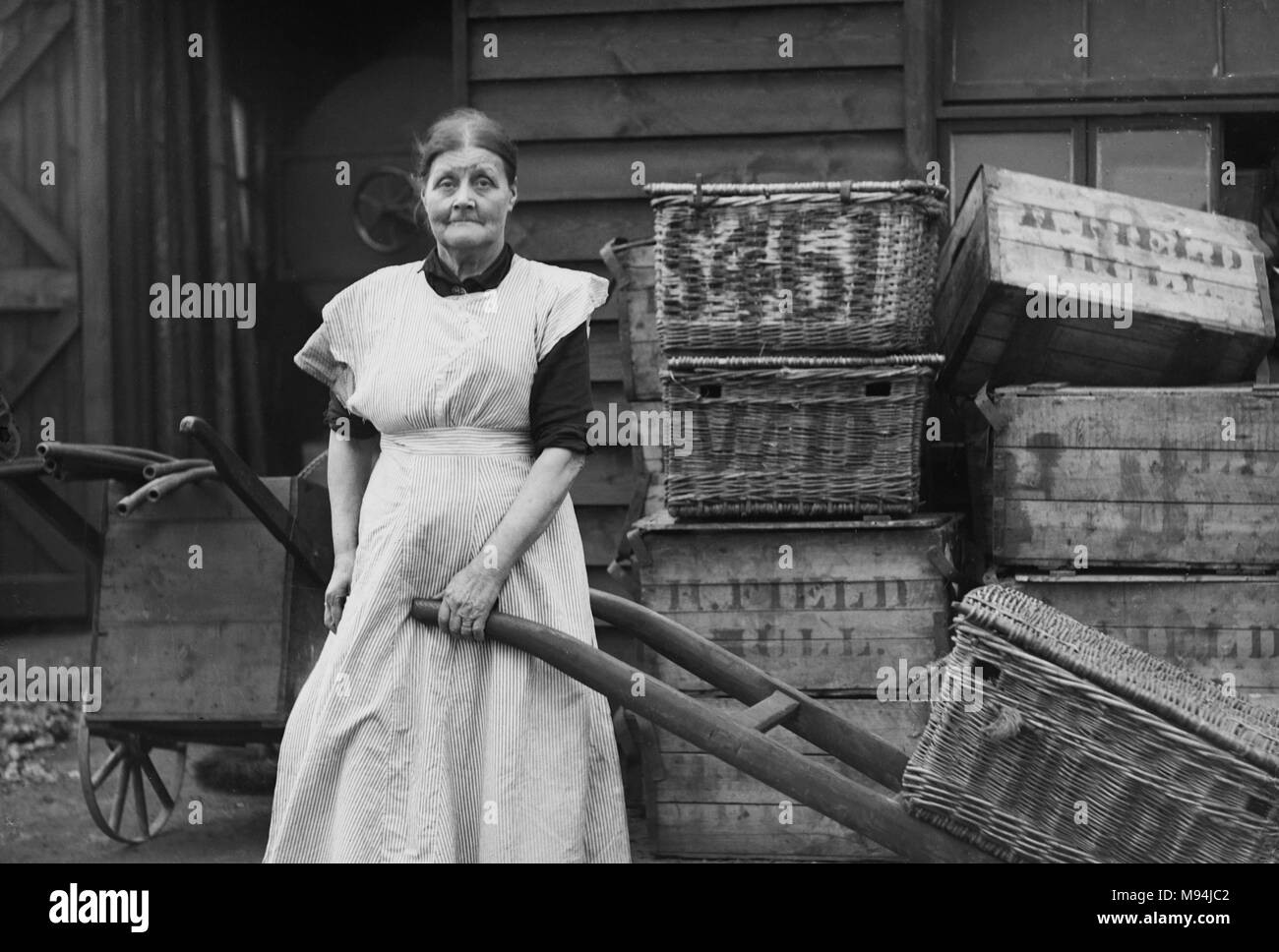 Working woman on the streets of London is shown in a vintage glass negative, ca. 1910. Stock Photo