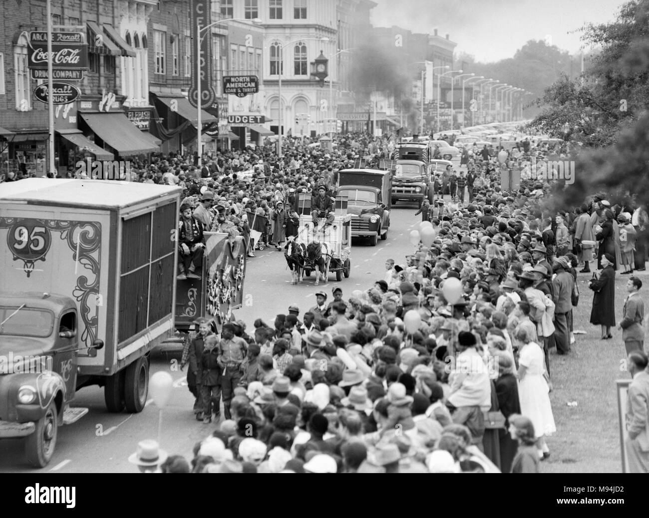 A circus parade winds its way through a small Georgian town, ca. 1948. Stock Photo